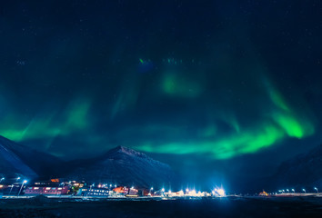 The polar arctic Northern lights aurora borealis sky star in Norway Svalbard in Longyearbyen city mountains