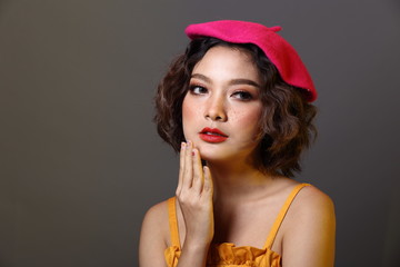 Korean Girl with freckles on face curl short hair pink cap yellow dress