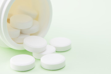 white pills spilling out of the bottle