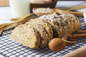 Top view of sliced wholegrain bread on a wooden cutting board.