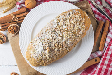 Top view of sliced wholegrain bread on a wooden cutting board.