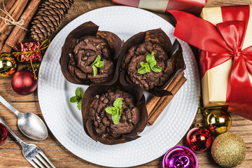 Chocolate muffin and branches fir. Christmas time.