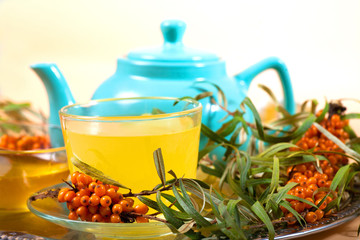 Tea made from sea buckthorn berries healthy for health delicious, saturated with vitamins surrounded by berries and sea buckthorn leaves for family tea drinking and maintaining health in the body
