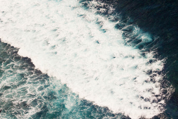 View of white foam of waves from the cliff in Bali, Indonesia