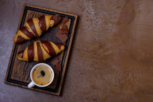 Cup coffee and chocolate croissant