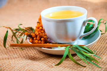 Tea made from sea buckthorn berries healthy for health delicious, saturated with vitamins surrounded by berries and sea buckthorn leaves for family tea drinking and maintaining health in the body