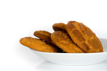 oatmeal cookies in plate isolated on white background