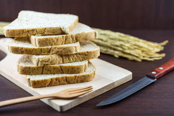 Sliced Whole wheat bread on Chopping Wood and hand knitted background