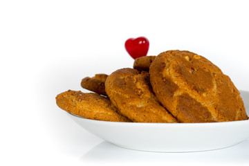 oatmeal cookies with red heart shape isolated on white background