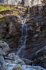 Waterfall at summer sunny day. Dolomites Alps, Rosengarden Group, South Tirol, Italy.