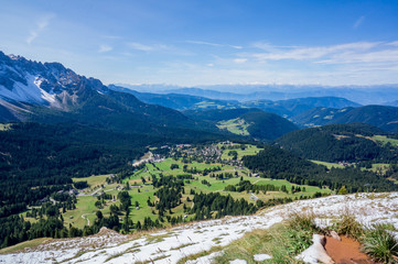 Snow mountains and green valley at summer sunny day. Dolomites Alps, Rosengarden Group, South Tirol, Italy.