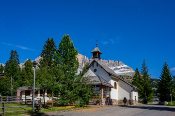 Fototapeta premium Wooden church in village. Dolomites Alps, Rosengarden Group, South Tirol, Italy.