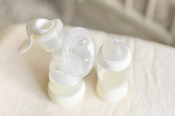 Fototapeta na wymiar Breast pump and bottle with milk for baby