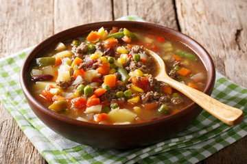 Tomato soup with ground beef and vegetables close-up on the table. horizontal