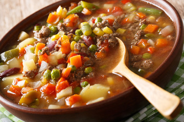 Delicious hamburger soup with ground beef and mix of vegetables close-up. horizontal