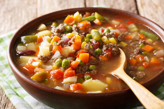 Homemade soup with ground beef and vegetable mix close-up in a bowl. horizontal