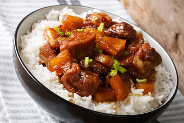 Filipino belly pork hamonado with pineapple and rice close-up. horizontal