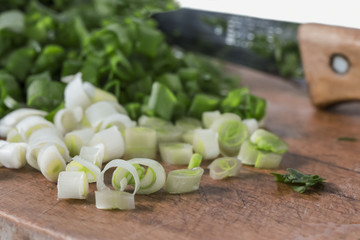 finely chopped green onion on a board