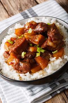 Pork Hamonado is a Filipino dish that involves cooking the meat in pineapple juice with rice. vertical