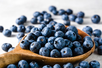 Blueberries. Spoon with berries isolated on white background.
