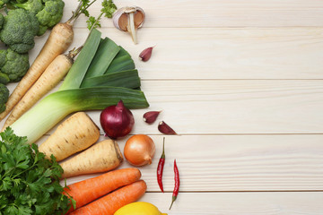 Fresh vegetables on white wooden background. Mockup for menu or recipe. Top view with copy space