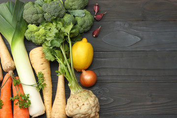 Fresh vegetables on dark wooden background. Mockup for menu or recipe. Top view with copy space