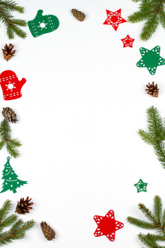 Christmas background with decorations, spruce branches and pine cones. Christmas pattern on white background. View from above, top, vertical
