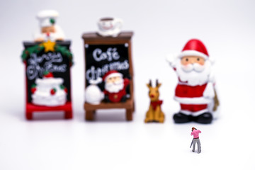 Miniature People : cameraman with Santa Claus doll and his reindeer