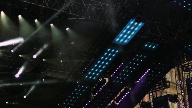 Dim Light Of Scene In Concert. Concert Stage Light Search With Particles colorful.