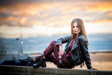 Cool girl in black leather jackets at sunset