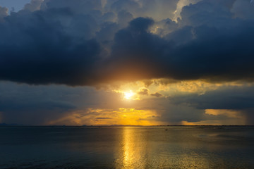 Sunset at the lake with dark cloud.