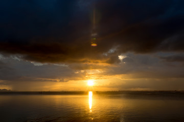 Sunset at the lake with dark cloud.
