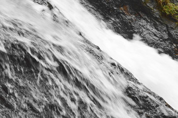 waterfall falling and hit rock splashing to river