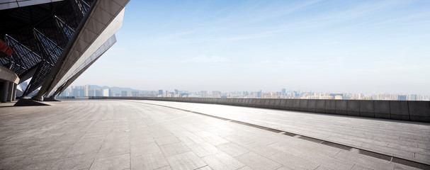 empty brick floor with modern cityscape in foggy day