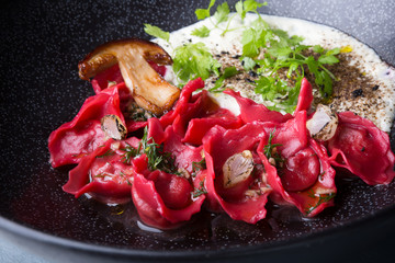 Red ravioli with mushrooms