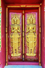 close up doors bass-relief in Beautiful temple Wat Samai Kongka on Ko Pha Ngan, Thailand.