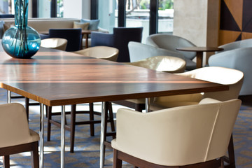 Working interior. Light leather chairs and brown wooden table.