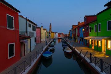 Fototapeta na wymiar Colorful houses and boats at night in Burano, Venice Italy.