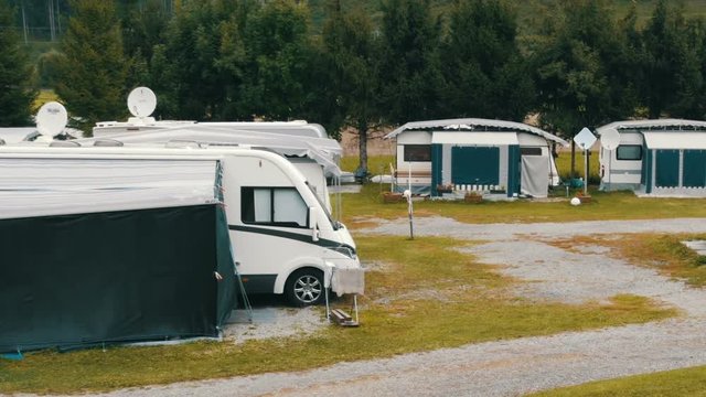 September 8, 2017 - Unterterl, Austria: Parking camping in which many trailers and in which people live. Picturesque Austrian valley on which there is a campsite