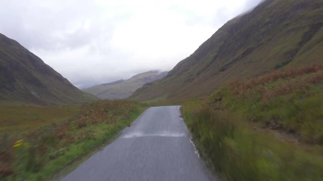 Driving on a road in Wild Glen Etive Valley in Scotland