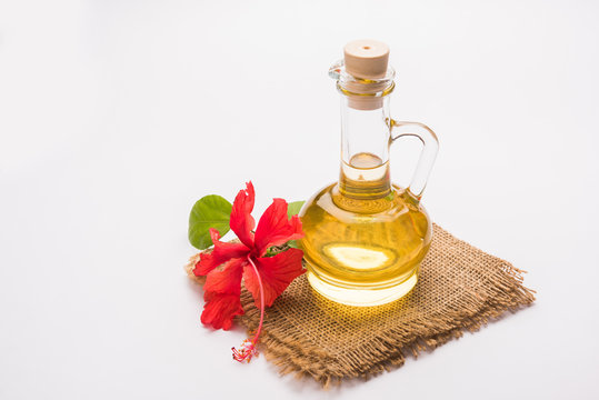 Jaswand or Hibiscus oil and bath soap/shampoo with flower and Reetha fruit and white towel
