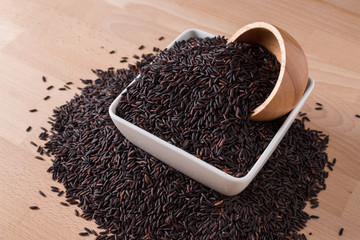 Rice berry on wood background