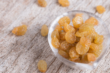 Dried yellow raisin fruits on  wood background