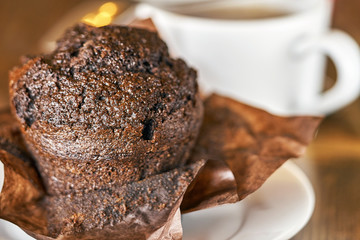 Delocious chocolate muffin with a cup of tea close up