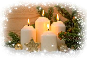 Fototapeta na wymiar Four burning Advent candles and snow.