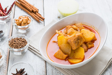 Massaman pork curry on wood background. Coconut milk curry.