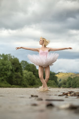 Fototapeta na wymiar Ballerina jumping above river