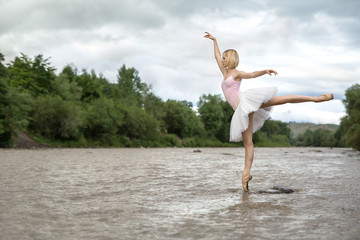 Ballerina posing in river