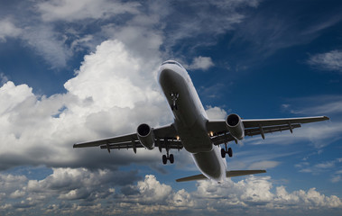 Airplane flying in sky with l clouds