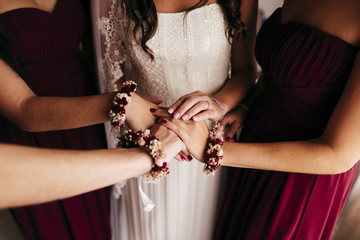 Bride and bridesmaids holding hands together